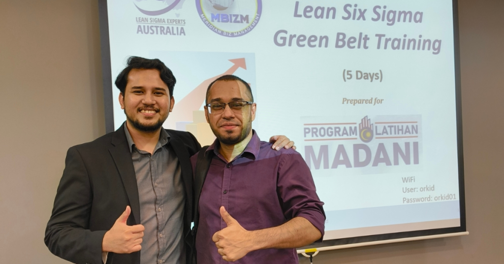 Trainer and participant of the Lean Six Sigma Green Belt Training, organized by MBizM Sdn. Bhd. under Program Latihan MADANI, posing together after a successful training session.