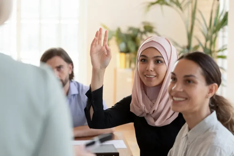 Participant raising her hand during a classroom Lean Six Sigma course