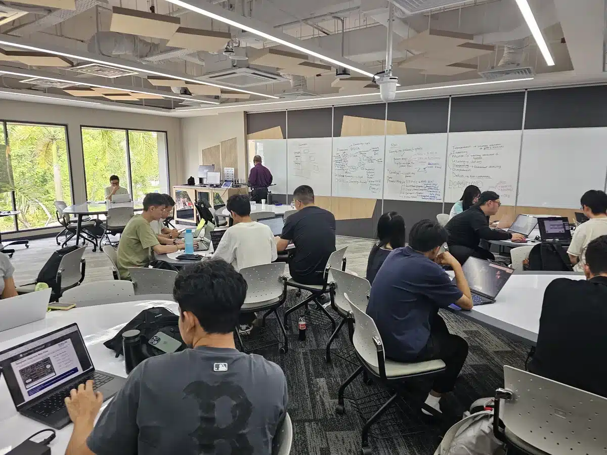 Monash University Malaysia students working on laptops during the Lean Practitioner workshop activities